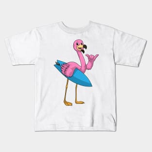 Flamingo as Surfer with Surfboard Kids T-Shirt